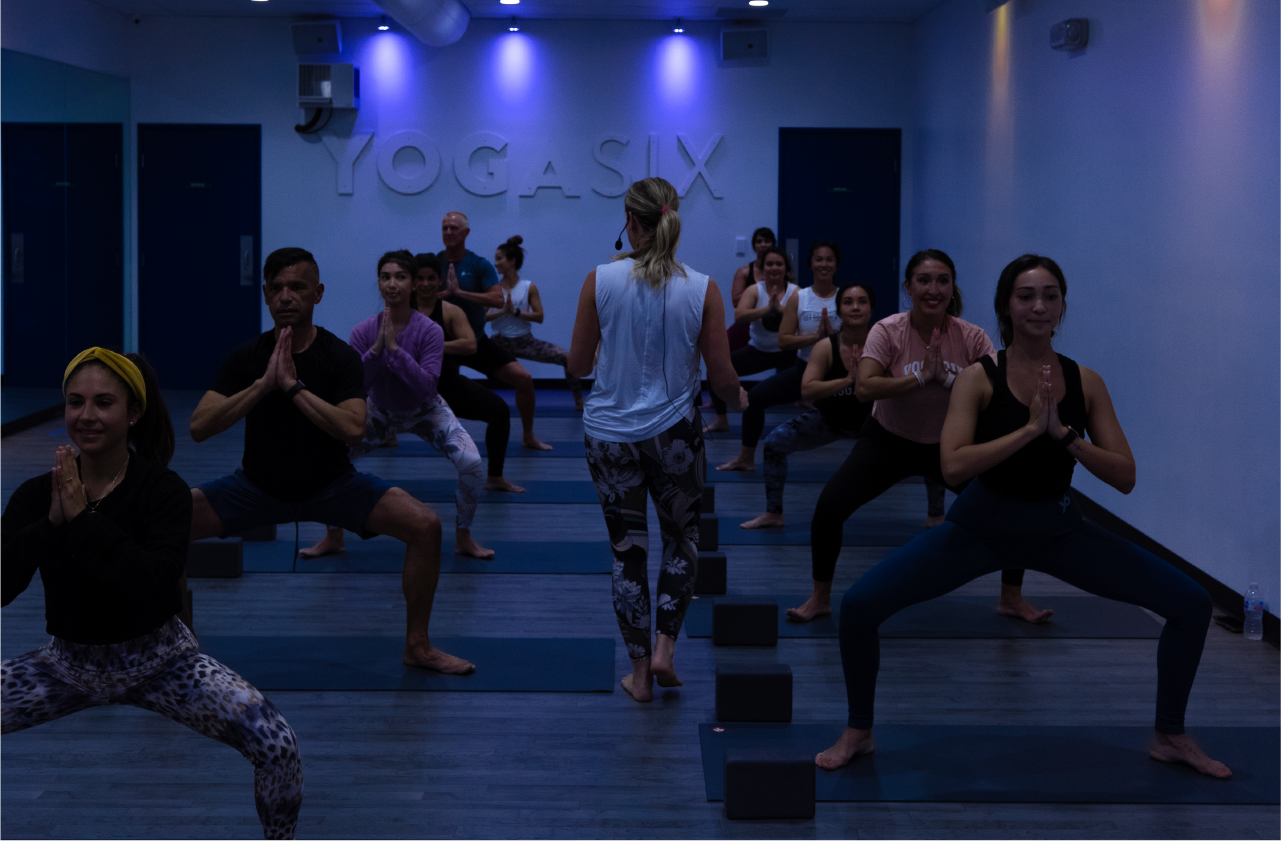 YogaSix instructor instructing yoga class